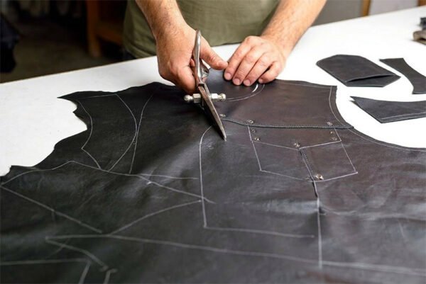 Cutting fresh leather for a vest